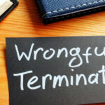 A paper with the words “wrongful termination,” representing best practices for preventing California wrongful termination claims during a RIF.