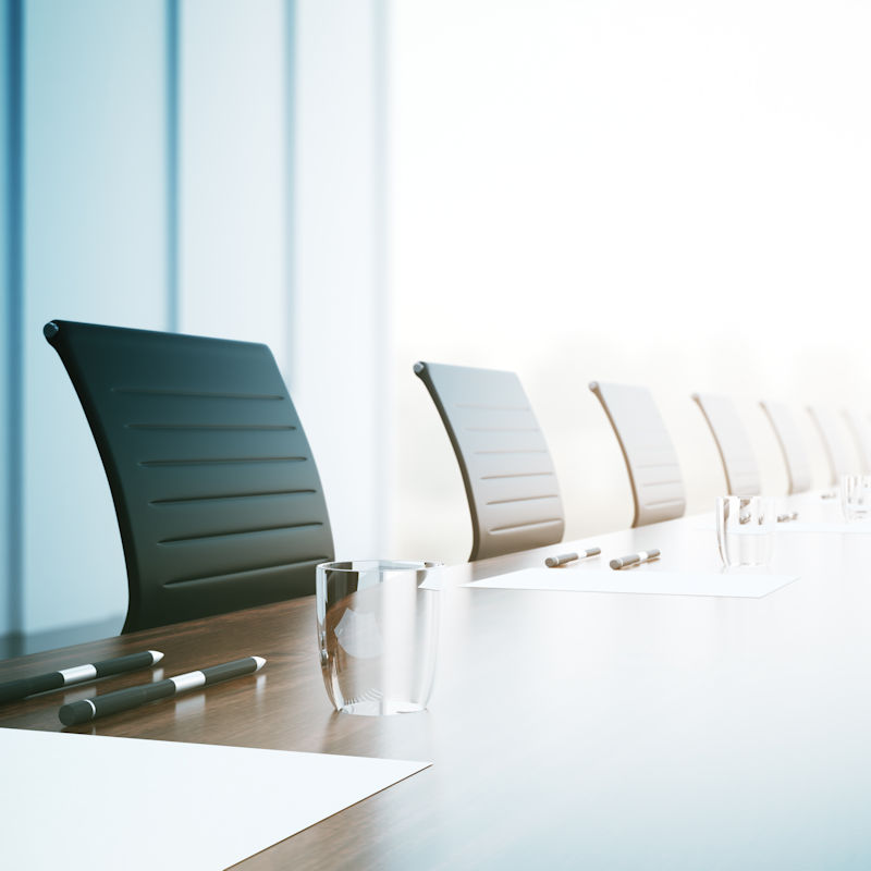 Image of chairs and table in a conference room, representing the value of consulting with experienced PAGA counsel for employers.